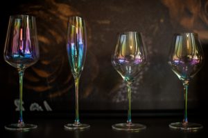 four iridescent wine glasses